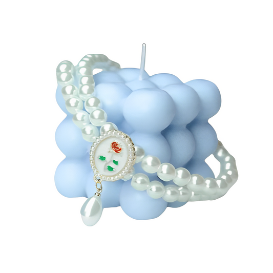 Small dog wearing gem pendant pearl necklace with lace accents