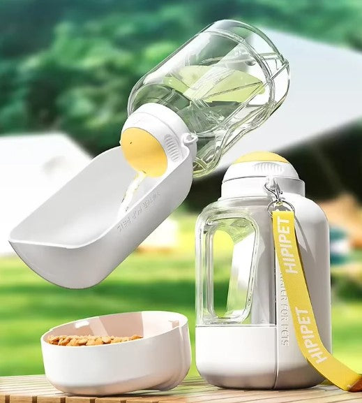 White portable dog water bottle and food bowl with water and kibble for outdoor use