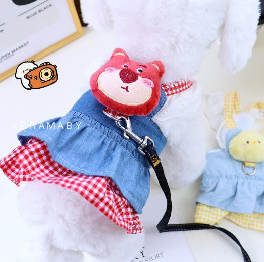Small white dog wearing a blue and pink dog harness with attached leash, perfect for stylish and safe walks