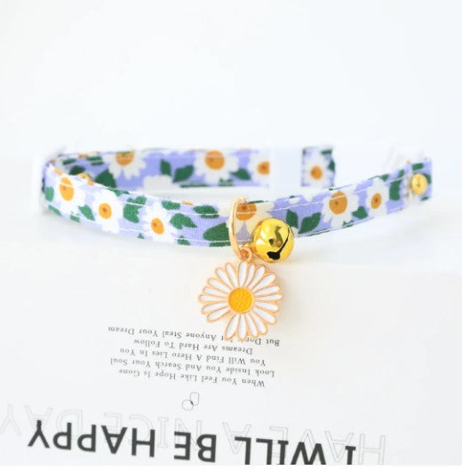 Blue cat collar with floral embellishments, featuring a golden bell and flower pendant