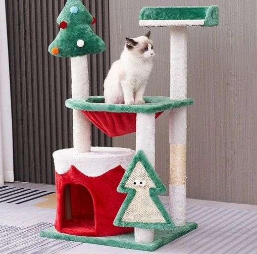 Christmas-themed cat tree with red, green, and white colors featuring a resting cat, cat condo at base, and Christmas tree-shaped scratching board