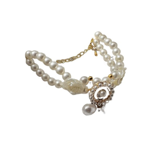Small dog wearing antique pearl floral necklace with zircon accents