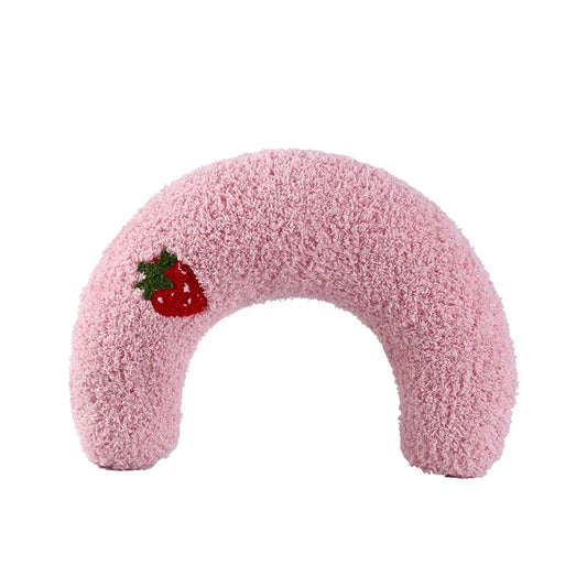 Cat resting on small U-shaped pet pillow in soft plush fabric