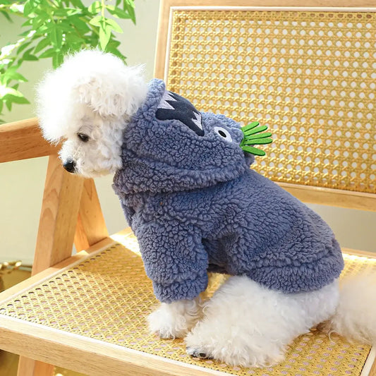 Small dog wearing a thick plush Halloween hoodie coat for chilly weather.