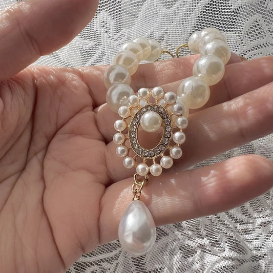 Small dog wearing antique pearl floral necklace with zircon accents