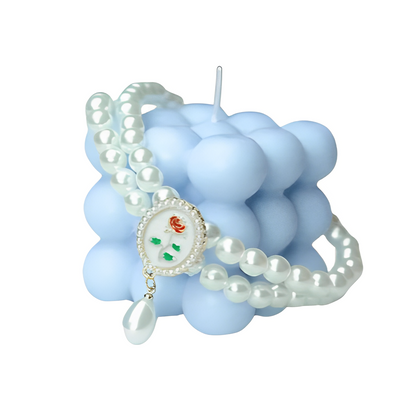 Small dog wearing gem pendant pearl necklace with lace accents