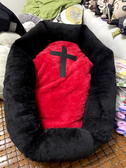 Cat sleeping in a Halloween-themed plush pet nest bed.