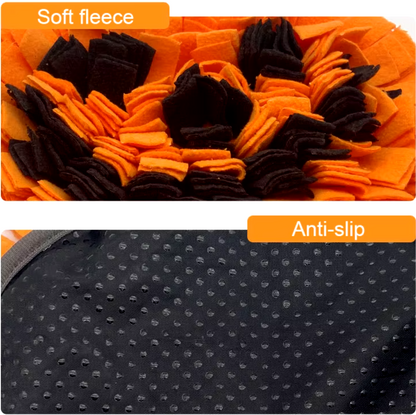 Dog sniffing a Halloween-themed pumpkin snuffle mat for hidden treats.
