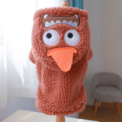 Small dog wearing a thick plush Halloween hoodie coat for chilly weather.