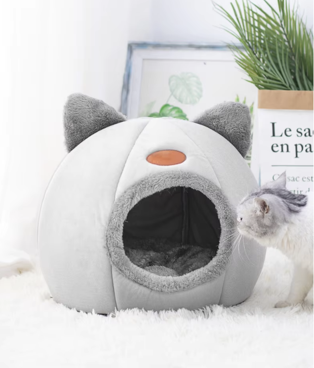 Cozy winter cat bed in cave design with removable cushion, perfect for keeping cats warm and comfortable during cold months.