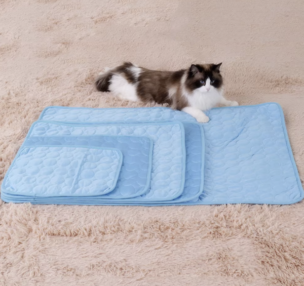 Pet cooling mat in ice silk fabric for summer comfort, suitable for dogs and cats in various sizes.