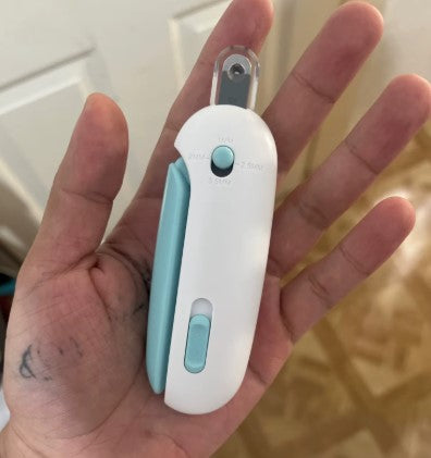 Close-up of a person holding a white and green pet nail clipper, designed for safe and precise trimming - Customer review photo