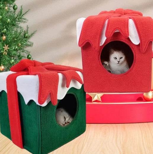 Two cats lounging in two Christmas gift box-shaped cat beds, one red and one green, perfect for holiday-themed pet comfort.