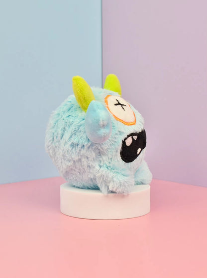 Small dog playing with a Halloween plush squeaky ball that moves.