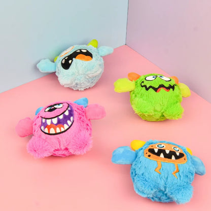 Small dog playing with a Halloween plush squeaky ball that moves.