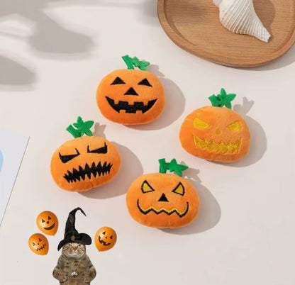 Dog chewing on a Halloween pumpkin ghost face toy.