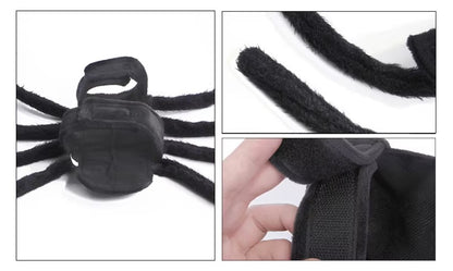 Dog dressed in a black Halloween spider costume with plush legs.