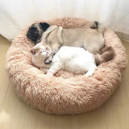 Ultra-soft round plush pet bed for cats and dogs, winter-ready with long plush fabric and non-slip base, available in sizes from 40cm to 90cm.