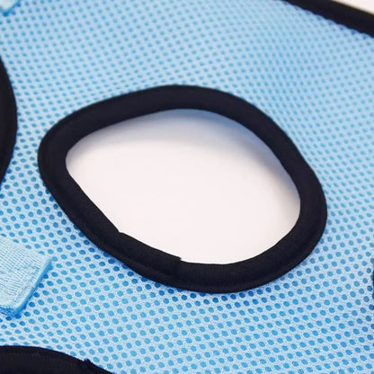 Cat suspended in a grooming hammock while getting its nails trimmed, safe and stress-free grooming tool