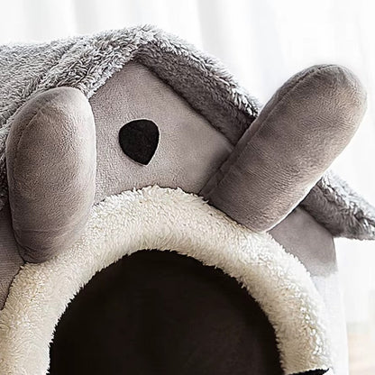 Small dog resting inside a foldable fleece dog kennel bed