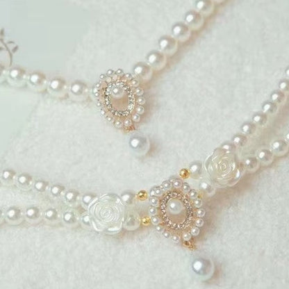 Small dog wearing antique pearl floral necklace with zircon accents