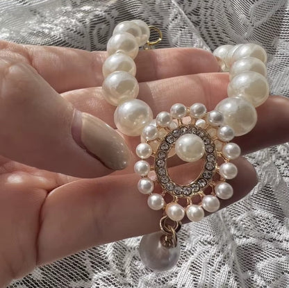 Small dog wearing antique pearl floral necklace with zircon accents