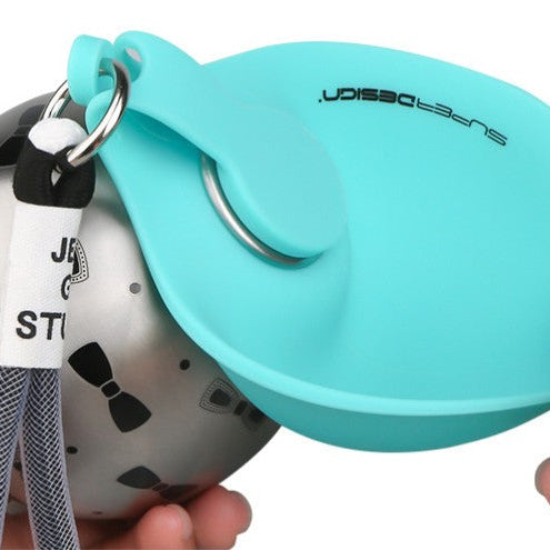 Close-up of the Dog Travel Water Bottle The Nomad™ Kinetic Hydration Orb with a teal silicone bowl.