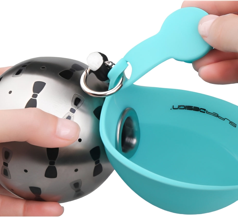 dog travel water bottle with silicone cup being opened and handled for hydration while outdoors.