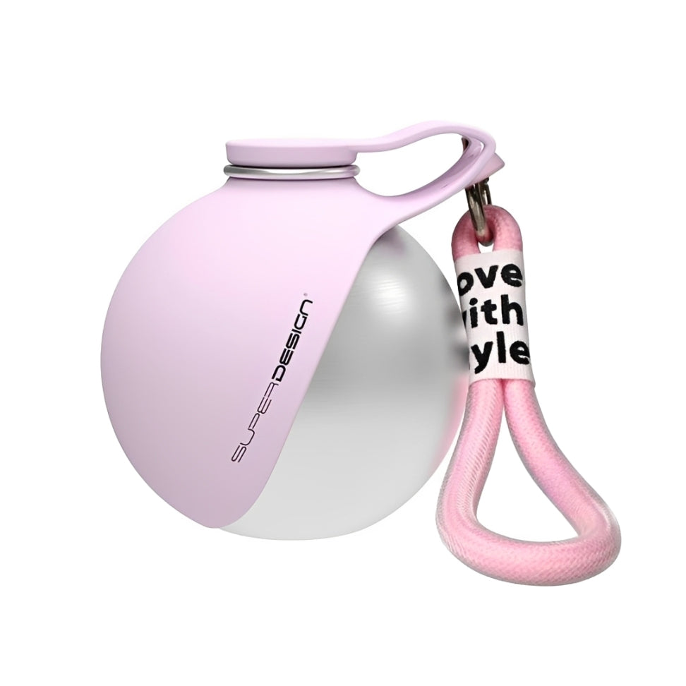 Dog travel water bottle The Nomad™ Kinetic Hydration Orb in pink with a clip for easy access.