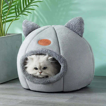 Deep sleep comfort cat bed in cave design, made with soft plush material and non-slip base for warm, cozy winter sleep.