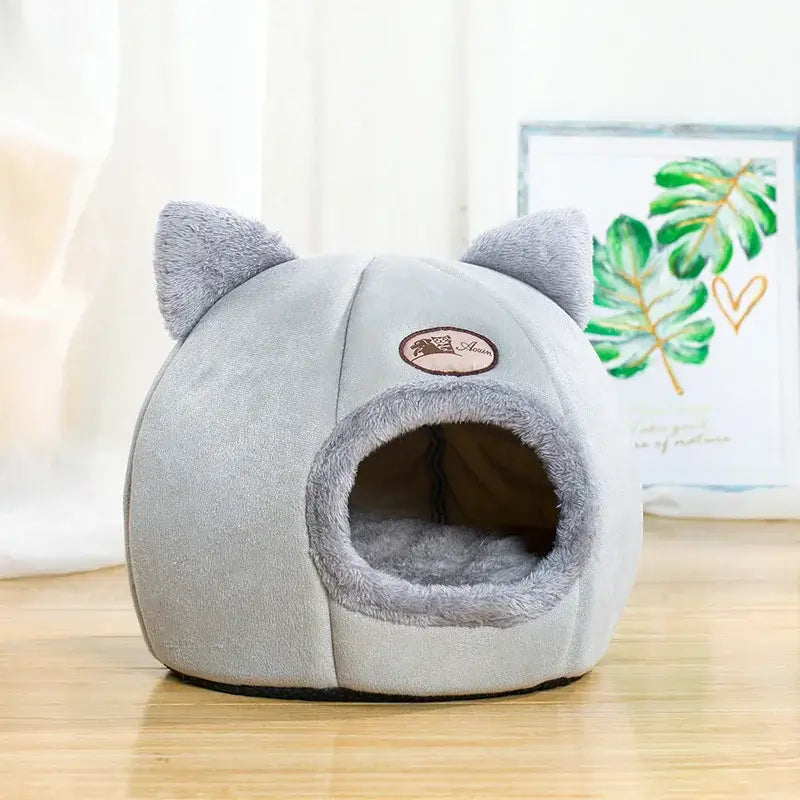 Cozy winter cat bed in cave design with removable cushion, perfect for keeping cats warm and comfortable during cold months.