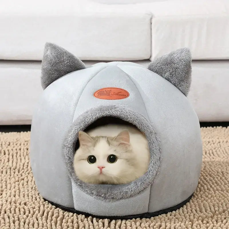 Cozy winter cat bed in cave design with removable cushion, perfect for keeping cats warm and comfortable during cold months.