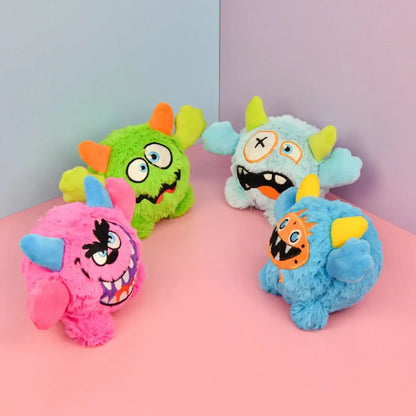 Small dog playing with a Halloween plush squeaky ball that moves.