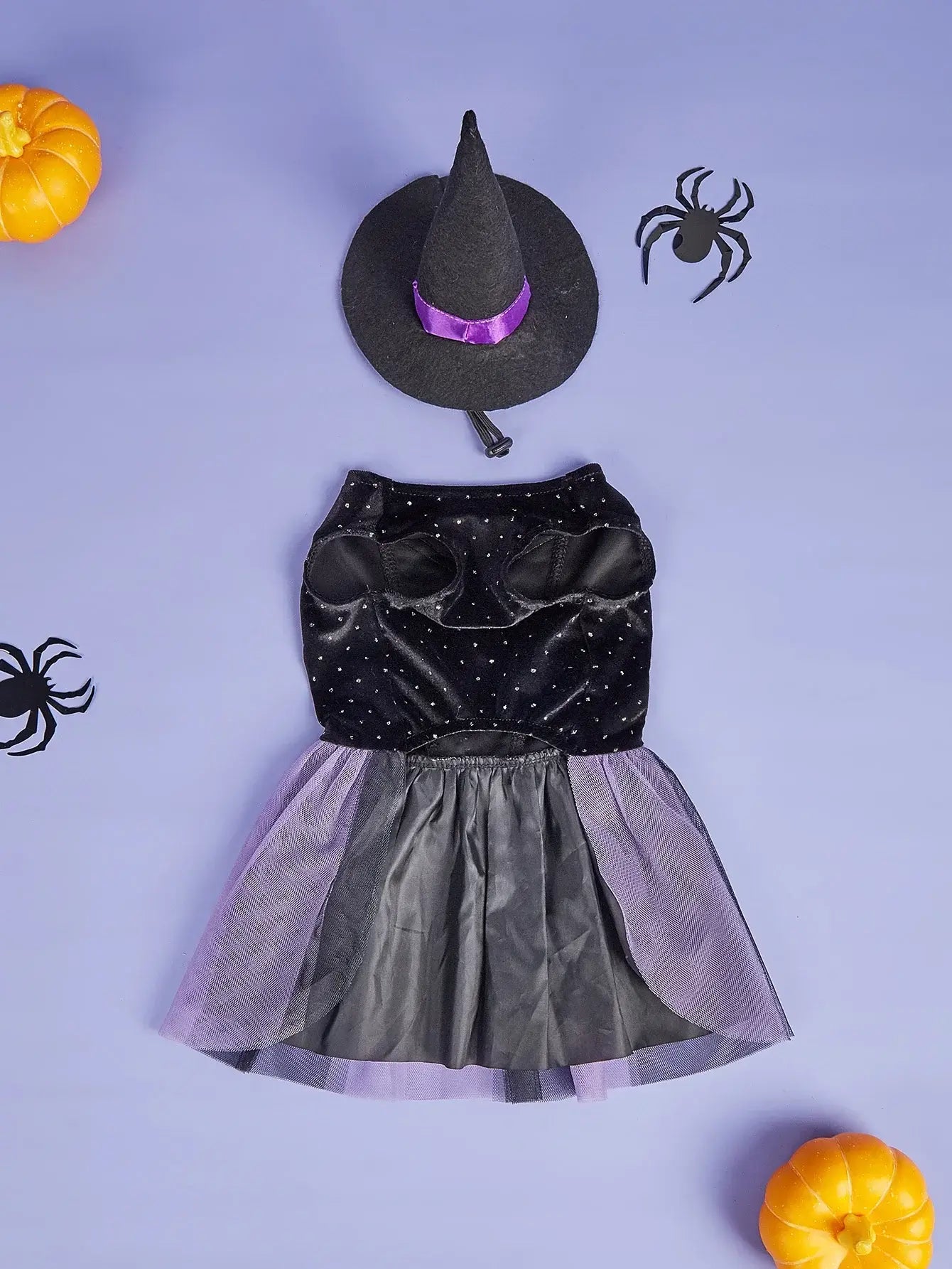 Small dog wearing velvet Halloween dog dress with tulle tutu and witch hat, perfect for Halloween parties or pet photoshoots.