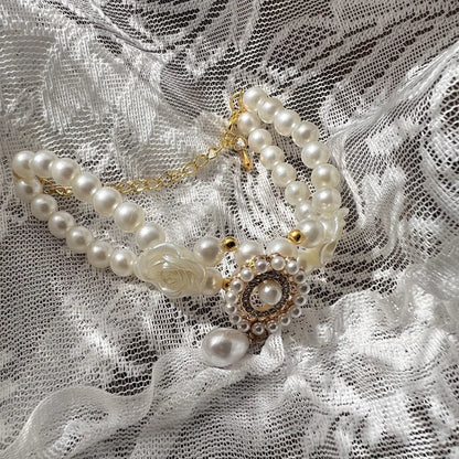 Small dog wearing antique pearl floral necklace with zircon accents