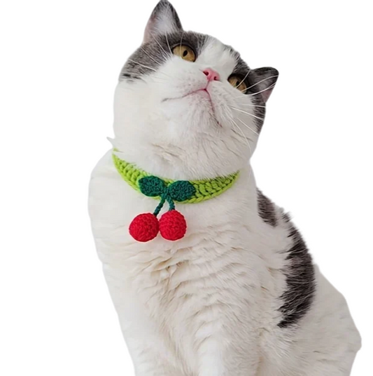 Handmade knitted pet collar with cherry decor for cats. Adjustable and stylish design for festive occasions.