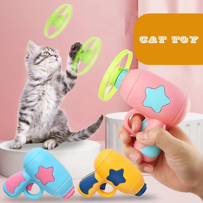Cat jumping to catch a flying disc launched by interactive cat toy