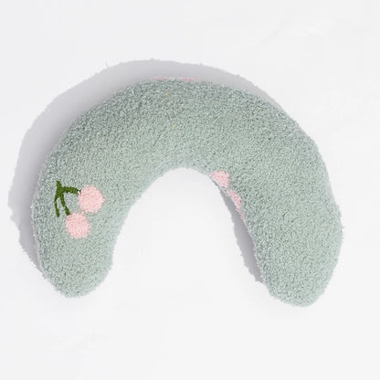 Cat resting on small U-shaped pet pillow in soft plush fabric