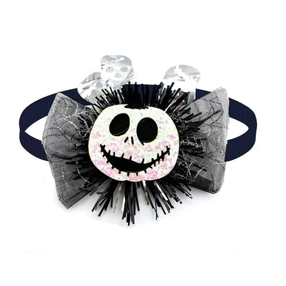 Dog wearing a cute pumpkin and skull Halloween bow tie for festive fun.