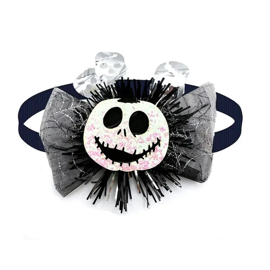 Dog wearing a cute pumpkin and skull Halloween bow tie for festive fun.