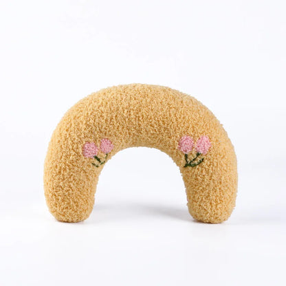 Cat resting on small U-shaped pet pillow in soft plush fabric