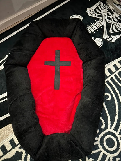 Cat sleeping in a Halloween-themed plush pet nest bed.