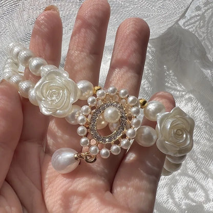 Small dog wearing antique pearl floral necklace with zircon accents