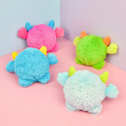 Small dog playing with a Halloween plush squeaky ball that moves.