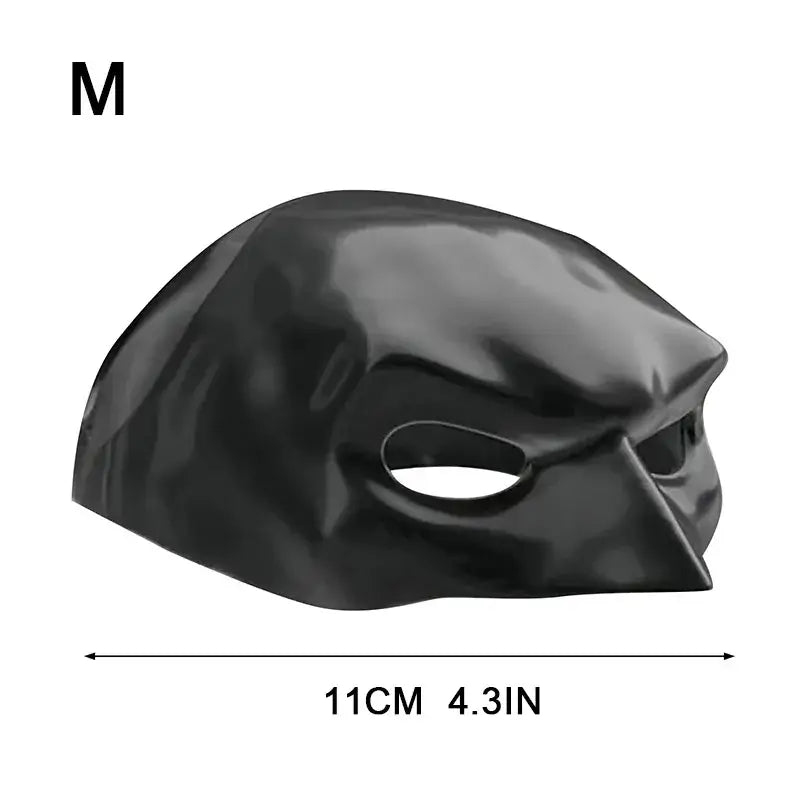 Cat wearing a black bat-inspired superhero mask, posing confidently for Halloween.