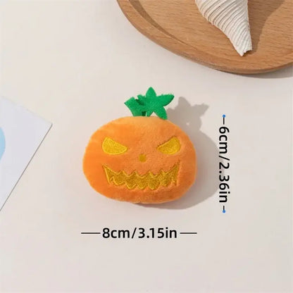 Dog chewing on a Halloween pumpkin ghost face toy.