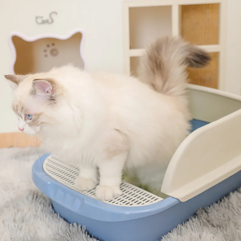 Large semi-enclosed cat litter box with high splash-guard border, available in blue, grey, and pink, designed for easy cleaning and odor control.