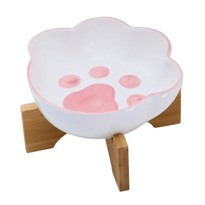 Cat paw-shaped ceramic pet bowl with bamboo stand, perfect for cats and dogs.