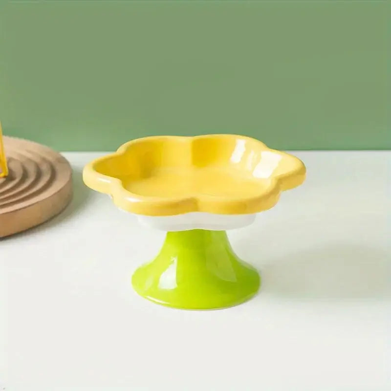 Ceramic raised cat bowl with flower design, ergonomic elevated dish for food and water, ensuring neck protection and comfort during mealtime.