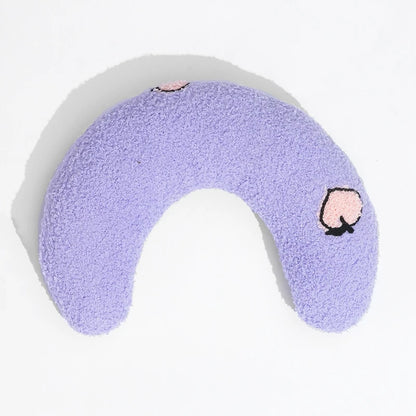 Cat resting on small U-shaped pet pillow in soft plush fabric